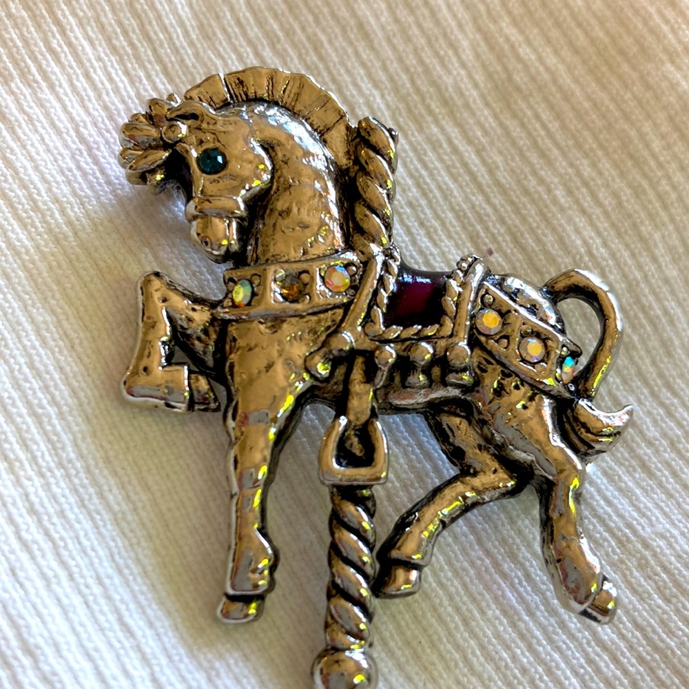 Danecraft carousel horse brooch with faux pearl with Aurora borealis.